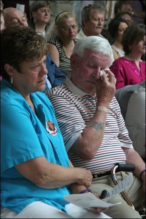 Barbara and Bob Hurt, whose daughter Lisa was stabbed to death by her husband three years ago, attend the opening ceremony for the Cocoon Shelter, Wood County s first shelter for battered women. The Hurts have lent their daughter s name to an endowment fund being set up to help the shelter s work.

