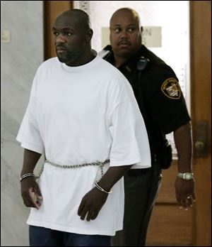 A sheriff s deputy escorts Donnie Ray Hughes out of Lucas
County Common Pleas Court after he was convicted.