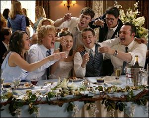 Owen Wilson, second from left in foreground, and Vince Vaughn, right, play divorce lawyers who show up at wedding receptions looking for free food, drinks, and bridesmaids.