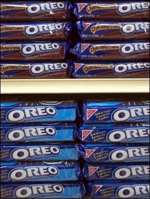 Oreo cookies, made by Kraft Foods Inc., are on a shelf in a grocery store in Wilmette, Illinois on Tuesday, April 20, 2004. Altria Group, Inc., the parent company of Kraft announced its profits from Kraft fell 32 percent because of $308 million in expenses from previously announced factory closings and job cuts. Altria's net income rose to $2.19 billion, or $1.07 a share. Sales climbed 13 percent to $21.8 billion to $19.4 billion.  Photographer: Tannen Maury/Bloomberg News