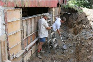 Miller and Fry dig around the barn.