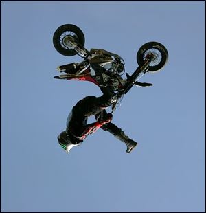 NBR motorcycle23p 04 - Preston Landers, of Texas, shows off his motorcycle skills at the Thunder at the Crossroads event at North Coast Motorcycles in Rossford.  The Blade/Allan Detrich