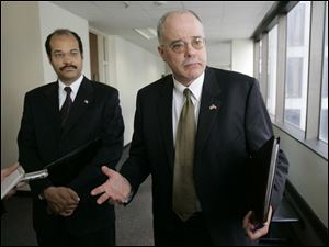 Gregg Thornton, Ohio's first deputy inspector general, left, and David Freel, executive director of the Ohio Ethics Commission, meet with reporters in Columbus on Friday.