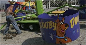 Drew Woodruff prepares a ride for the 129th annual Attica Independent Fair that starts today.