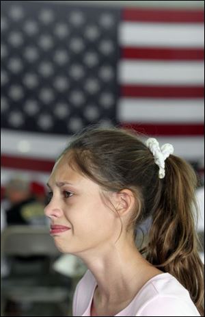 Kara Danner, 12, at left, was at the ceremony because her father is in the unit being deployed.
