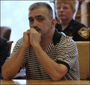 John Bedford, a former wrestling coach at Woodmore High School, looks over at the victims as they give impact statements during his sentencing hearing in Ottawa County Common Pleas Court. Bedford was sentenced to 180 days in jail and classified as a sexually oriented offender for offering six female students at the high school money if they would have sex with him.