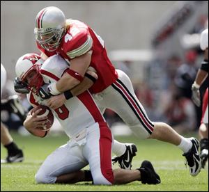 Ohio State linebacker Bobby Carpenter sacks Miami quarterback Josh Betts for a 10-yard loss in the first quarter.