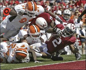 Brian Calhoun rushed through and around the Bowling Green defense for 258 yards and a Wisconsin-record five touchdowns. 

Omar Jacobs threw for 458 yards and five touchdowns. The yardage was second-best in BG history behind Brian McClure s 479 against Ohio in 1985.