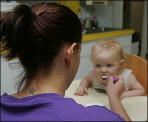 Day-care worker Jodi Adamczewski remembers her boss being surprised by her tattoos.
