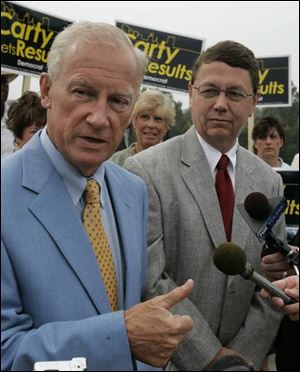 Carty Finkbeiner, foreground, and Councilman Rob Ludeman field questions at a press conference where Mr. Ludeman, a Republican, announced his support for Mr. Finkbeiner, a Democrat, in the mayoral race. Separately, Mayor Jack Ford said he would not seek the Democratic endorsement in the race, ceding it to Mr. Finkbeiner, whose allies control the party apparatus.