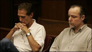 Rick Ross, left, and his brother Larry Ross, owners of University Properties, listen as the judge says that the two were working a 
