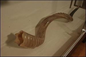Displays, from 'Judaica Toledo: A Centennial Celebration, Traditions and Treasures of the Toledo Jewish Community,' connected to Rosh Hashanah include the ram's horn.
