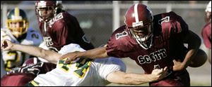 Clay defender Brad Stanton forces a fumble by Scott's Darell Brown in the second quarter yesterday as the Eagles built a 17-0 lead over the Bulldogs by halftime at Penn/Webb Stadium. 