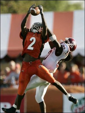 BGSU cornerback Jelani Jordan steals a pass intended for Temple receiver Bruce Gordon, one of two interceptions for him against the Owls. The Falcon
defense picked off three passes and recovered two fumbles.