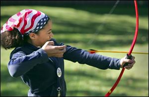 Rachel Harris of Pickerington, Ohio, works on her archery skills.