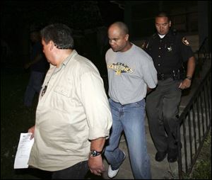 Julian Boose, center, is led away after being arrested for allegedly failing to pay support. lucas county