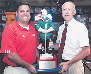 The Irish Knight is a valuable possession for Central coach Greg Dempsey, left, and Dick Cromwell of St. Francis.