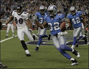 Lions' cornerback Dre Bly is off and running with one of his two interceptions on the day against the Baltimore Ravens.