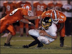 Southview s Nick Warren (54) sacks Northview s Mike Schneider as teammate Chris Mierzwiak closes in.
