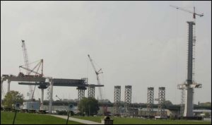 Work begins today to add three concrete pieces to the top of the towering central support for the I-280 Veterans' Glass City Skyway. 