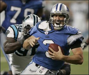 Carolina defensive end Al Wallace gets just enough of a handful of Detroit QB Joey Harrington's No. 3 jersey to sack him in the fourth quarter. Harrington had a pressure-filled afternoon, suffering six sacks for a total of 44 yards in losses and one interception.