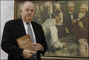 Henry Herschel, head of the Lucas County public defender's office, prizes this painting in his office, 'The Hung Jury.'