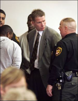 Peter Wolfram, a Maumee dentist, is led away in handcuffs after his sentencing in Lucas County Common Pleas Court.
