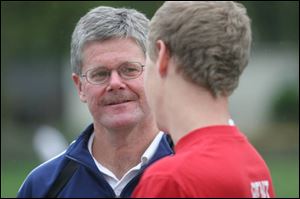 Toledo Christian coach Steve Pereus talks with Ben Tipping, an All-TAAC second-teamer.
