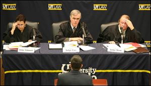 U.S. District Judges Nancy Edmunds, left, of Detroit and James Carr of Toledo and Ohio appellate Judge William Skow of Toledo listen to UT law student George Thomas.