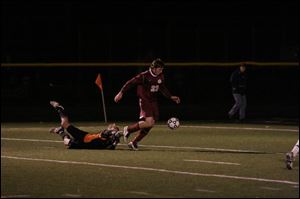 Genoa's Cory Hornyak gets past Fort Jennings goalkeeper Ross Gerdeman to score the first of his goals last night.