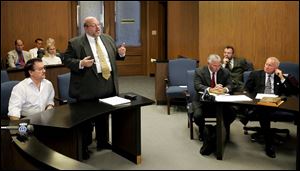 Restaurateur John Skiadas, left, listens to his lawyer, John Potts, in the course of his unsuccessful lawsuit. He claimed that Mr. Finkbeiner, right, caused an angina attack by poking him in the chest in 2000. As mayor, Mr. Finkbeiner was known for his volatile temper.