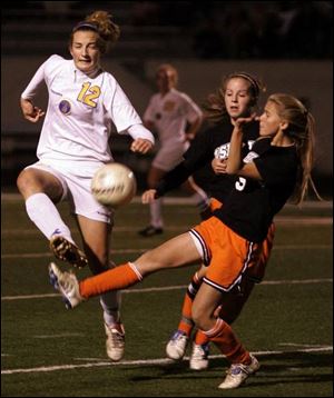 St. Ursula s Krystin Miller, left, tries to control the ball as Ashland defender Jamie Blair arrives to play defense, along with an unidentified teammate.
