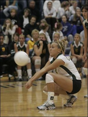 Clay s Kaitlyn Crawford is the picture of concentration as she digs one out against Elyria last night in Norwalk.
