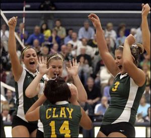 Clay High School players celebrate as they rallied against Elyria in the first game of last night's regional semifinal.
