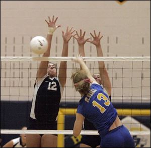 St. Ursula s Ashley Heyman (13) tries to spike the ball past two
Magnificat players in the fourth and final game of last night s regional semifinal. Heyman led St. Ursula with 13 kills.