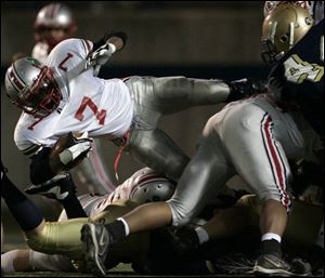Central Catholic's Chris Willis dives for yardage against St. John's Jesuit in the final game of the regular season. The Irish won, earning their first City League championship since 1982. Central, St. John's and Rogers all qualified for postseason play.