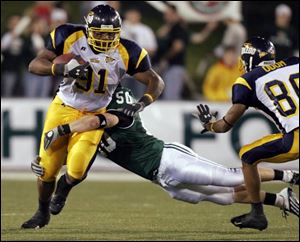 Toledo's Chris 
Hopkins (91) had clear sailing with the football until Ohio's Matt Muncy (50) avoided the block of the Rockets' Steve Odom (80) and made this tackle near the sidelines.
