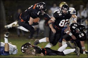 Liberty Center running back Brett Babcock goes airborne for
extra yardage against Sandusky St. Mary Central Catholic.
