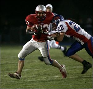 Patrick Henry s Josh Strub sheds a Wayne Trace defender last night. Strub scored a touchdown during a third-quarter surge.
