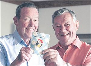 Harold C. Ackerman, left, and Ernie Bollinger hold the birthday card that they have been
sending to each other for more than 60 years.
