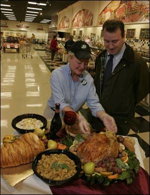 Tracy Clegg and Jonathan Heigel, of Bassett's Market in Sylvania, display the dinner available for customers to order.