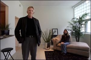 Jim Ott, of the development company, and Gwen Garrett, the design consultant, show off one of the units in the 1957 addition to the Victorian-era former Adams School.