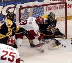 Toledo's Jeff Attard tries to push the puck past Johnstown goalie Morgan Cey in the first period of last night's game.