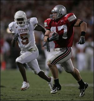 A.J. Hawk runs with the ball
after intercepting a pass
against Texas in September.