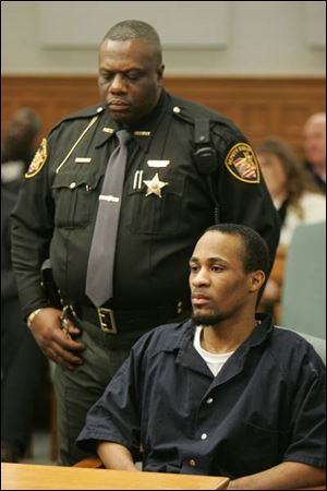 Deputy Troy Jackson guards convicted rapist Jeremy Quinn, Jr., during sentencing at Lucas County Common Pleas Court.