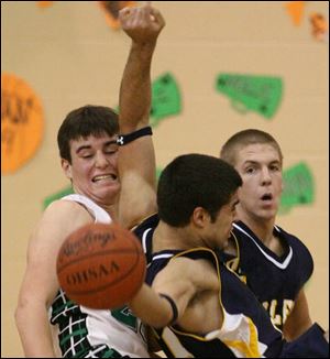 Ottawa Hills' Andrew Parker, left, and Toledo Christian's 
Andrew Mawer collide last night in TAAC basketball action.