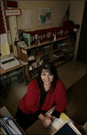Rogers High School secretary Norma Hernandez does double duty as the school's cheerleading coach.