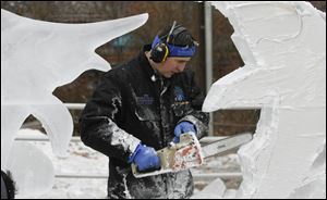 Ice sculptor Chad Hartson helps kick off the sixth annual Frozentoesen with a demonstration of his skill with the chain saw.