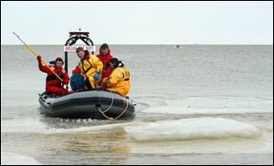 Oregon emergency personnel return to shore after plucking ice fishermen from a floe in Lake Erie in February, 2005. Bratton