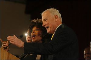 Mayor Carty Finkbeiner joins in singing 'We're Strong for Toledo' with Jean Holden, known as 'Toledo's First Lady of Song,' following his State of the City address at the University of Toledo.